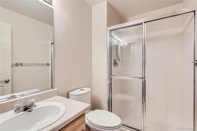 bathroom with vanity, toilet, and walk in shower