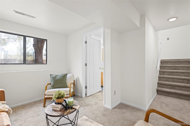 living area with light carpet