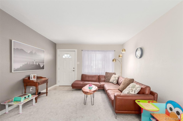 carpeted living area with baseboards