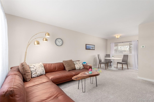carpeted living room with baseboards