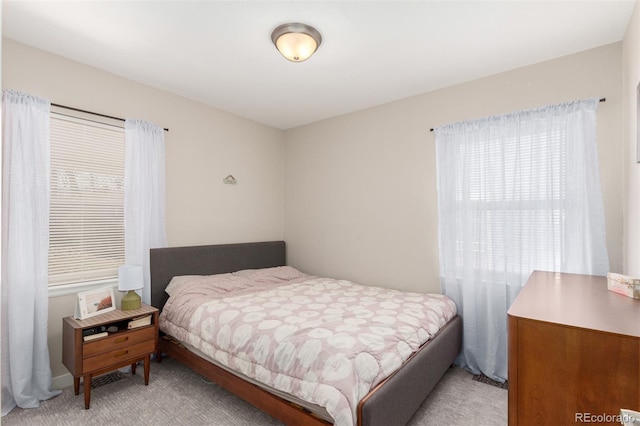 bedroom with light colored carpet