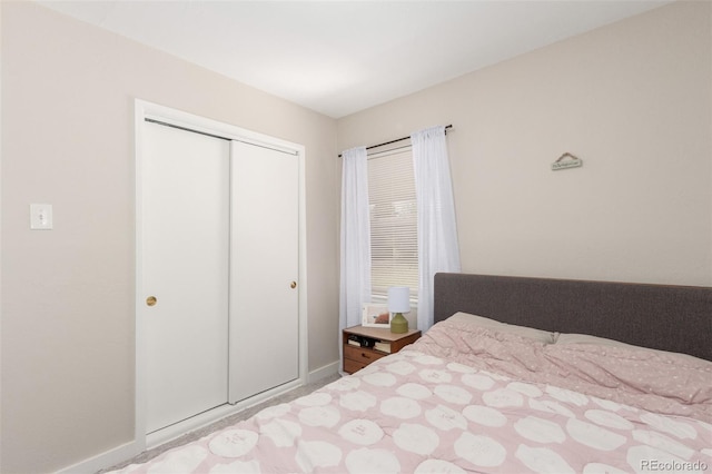 bedroom featuring a closet and baseboards