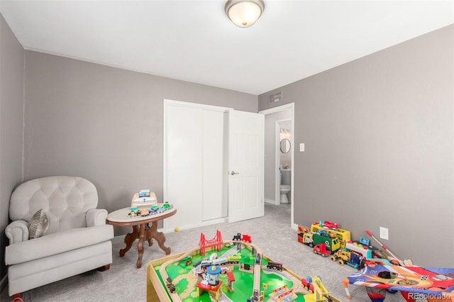 recreation room featuring baseboards, carpet flooring, and visible vents