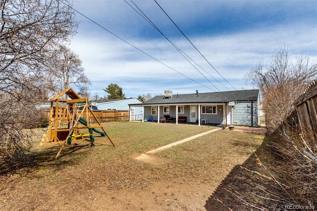 back of property featuring a lawn, a playground, a patio, and a fenced backyard