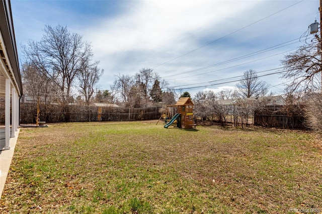 view of yard with a fenced backyard and a playground