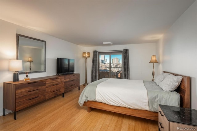 bedroom featuring light wood-type flooring and access to exterior