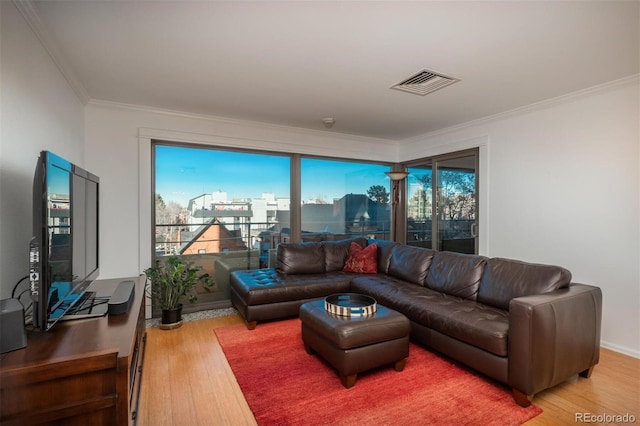 living room featuring crown molding and hardwood / wood-style flooring