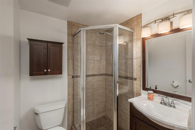 bathroom with toilet, walk in shower, and vanity