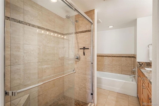 bathroom featuring tile patterned floors, vanity, and shower with separate bathtub