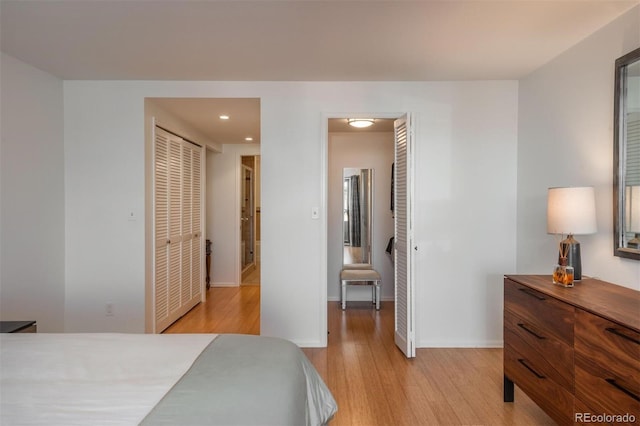 bedroom featuring a closet and light wood-type flooring