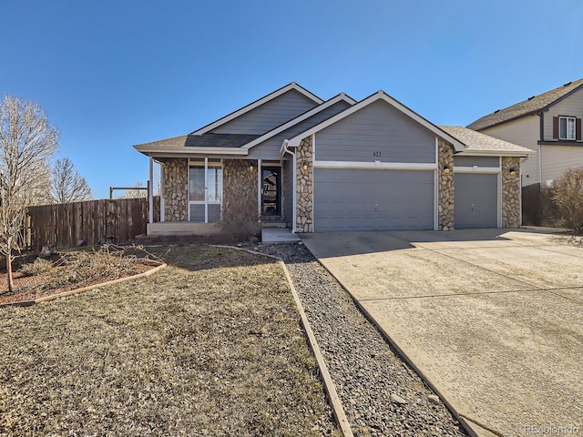 ranch-style home featuring stone siding, driveway, an attached garage, and fence