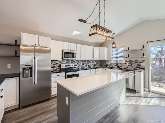 kitchen with open shelves, white cabinetry, and stainless steel appliances