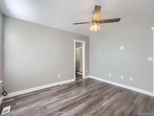 unfurnished room featuring ceiling fan, visible vents, baseboards, and wood finished floors