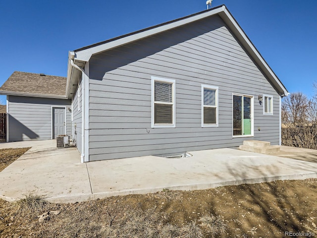 rear view of house featuring a patio area and central AC unit