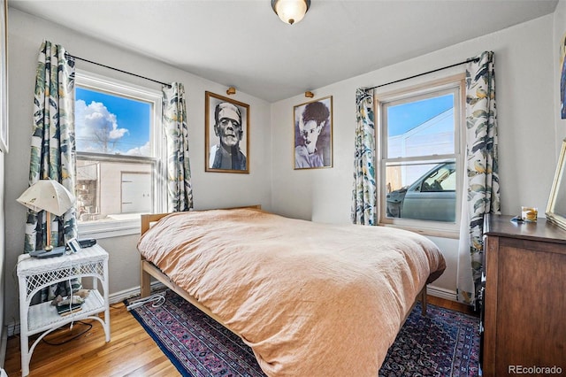 bedroom featuring baseboards and wood finished floors