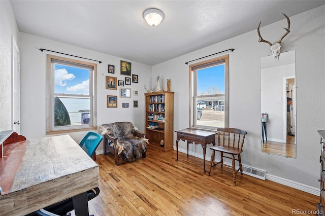 sitting room with light wood-style floors and baseboards