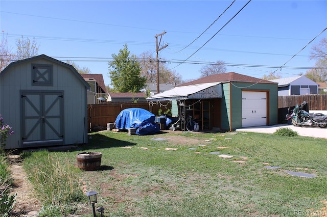 view of yard with fence and an outdoor structure