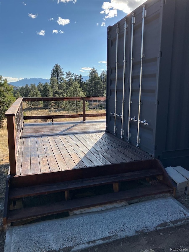 wooden deck featuring a mountain view