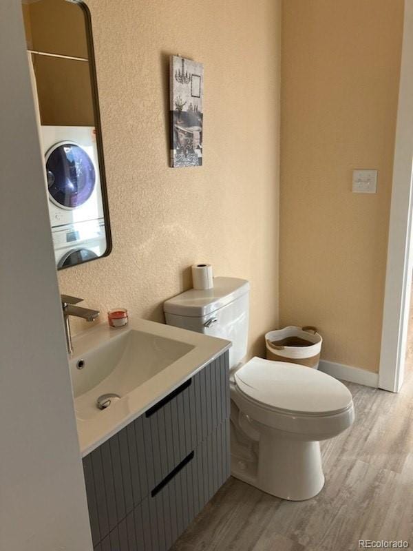 bathroom with vanity, washer / clothes dryer, hardwood / wood-style floors, and toilet