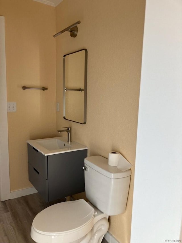 bathroom with vanity, hardwood / wood-style flooring, and toilet