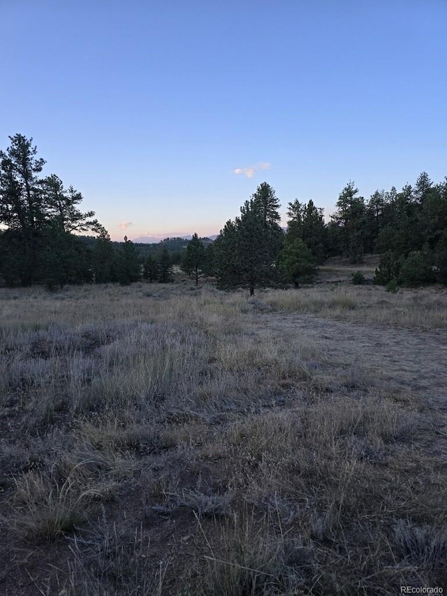 nature at dusk featuring a rural view