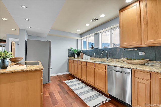 kitchen featuring light brown cabinetry, dark hardwood / wood-style floors, and stainless steel appliances