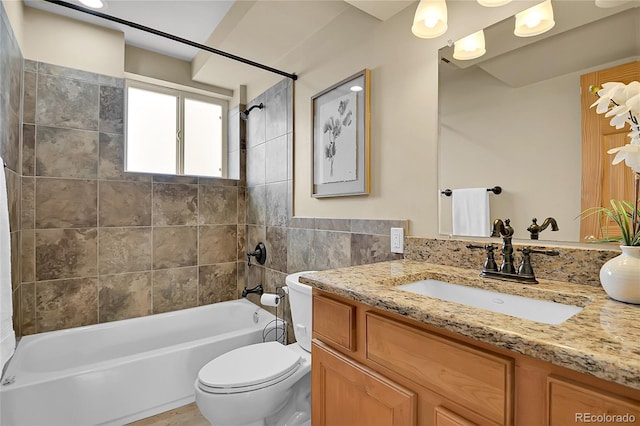 full bathroom with tiled shower / bath combo, toilet, and vanity