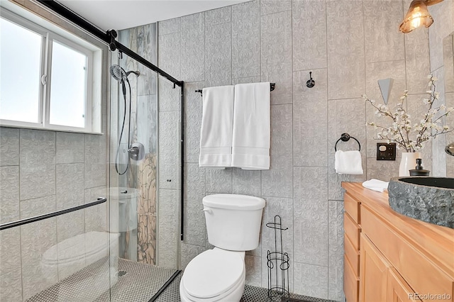 bathroom featuring toilet, tile walls, walk in shower, and vanity