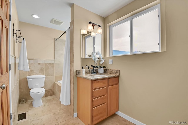 full bathroom with toilet, shower / bath combo with shower curtain, tile walls, tile patterned flooring, and vanity