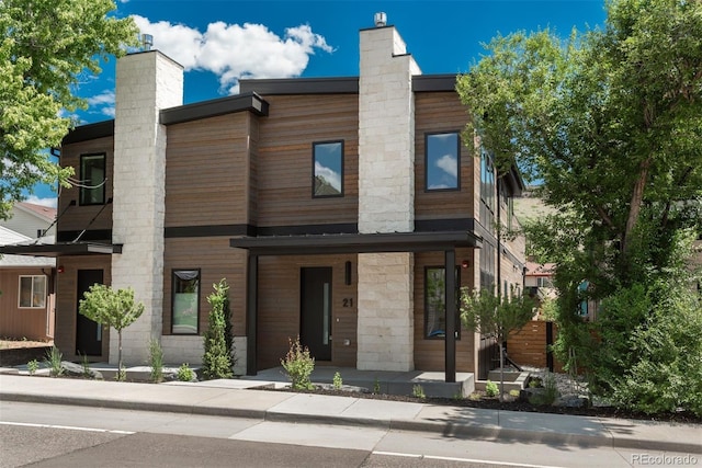 21 Washington Ave, Golden, CO 80403 - contemporary home featuring a chimney and covered porch