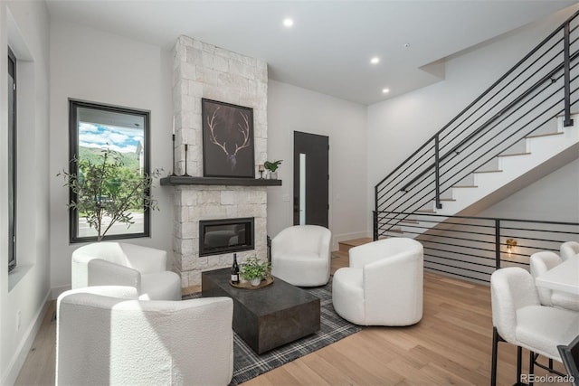 21 Washington Ave, Golden, CO 80403 - living room featuring wood finished floors, a stone fireplace, stairs, and recessed lighting