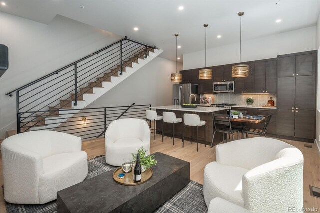 21 Washington Ave, Golden, CO 80403 - living room with light wood-style floors, stairs, and recessed lighting