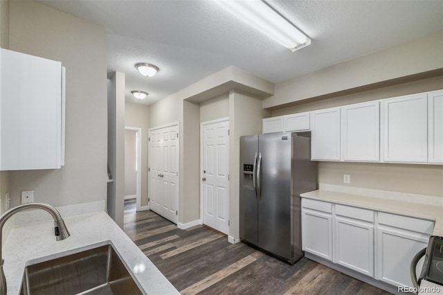 kitchen featuring sink, appliances with stainless steel finishes, white cabinetry, and dark hardwood / wood-style flooring