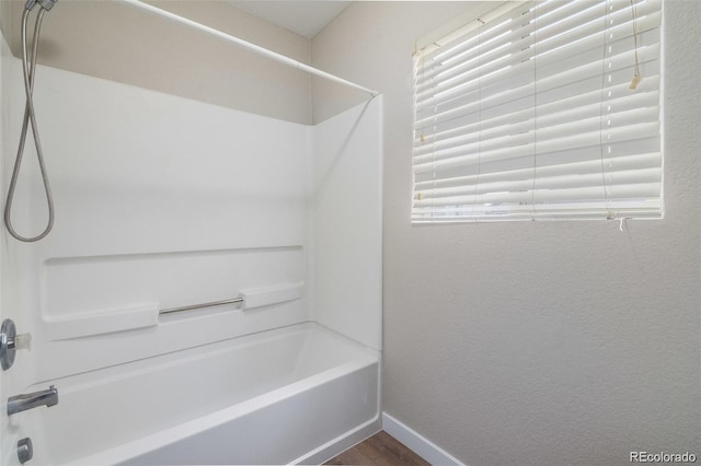 bathroom with hardwood / wood-style floors and shower / bathing tub combination