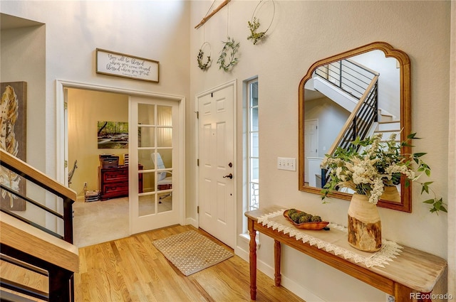 8229 Cottongrass Ct, Castle Pines, CO 80108 - foyer featuring wood finished floors, stairway, and a high ceiling