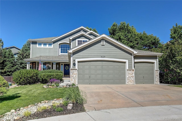 8229 Cottongrass Ct, Castle Pines, CO 80108 - craftsman-style home with concrete driveway, a garage, a front lawn, and stone siding