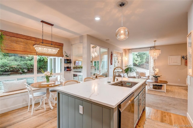 8229 Cottongrass Ct, Castle Pines, CO 80108 - kitchen featuring stainless steel dishwasher, a kitchen island with sink, a chandelier, gray cabinetry, and pendant lighting