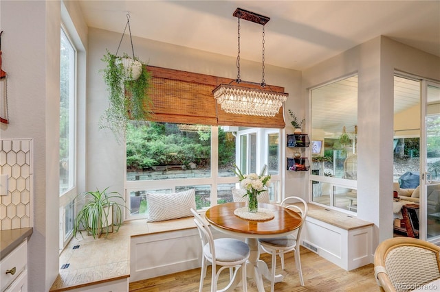 8229 Cottongrass Ct, Castle Pines, CO 80108 - dining space with light wood-style floors and a chandelier