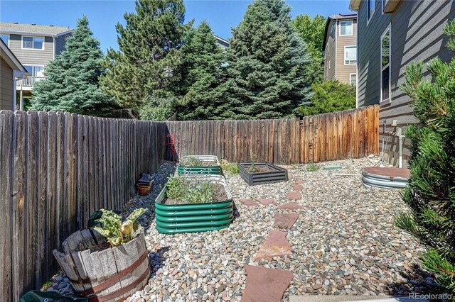 8229 Cottongrass Ct, Castle Pines, CO 80108 - fenced backyard with a vegetable garden