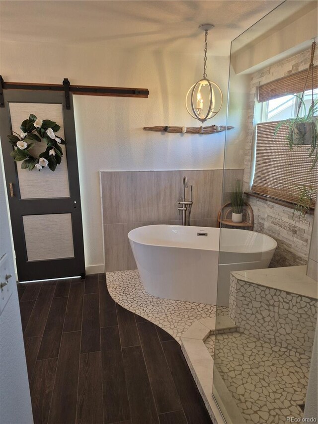 8229 Cottongrass Ct, Castle Pines, CO 80108 - bathroom with a soaking tub and wood finished floors