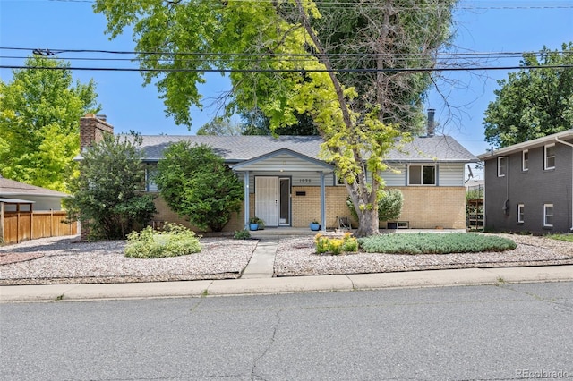 1026 Spencer St, Longmont, CO 80501 - view of front of property featuring brick siding and a chimney