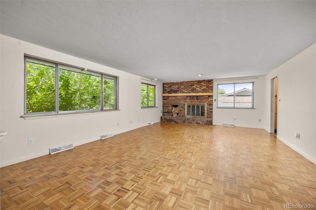 1026 Spencer St, Longmont, CO 80501 - unfurnished living room featuring plenty of natural light and a brick fireplace