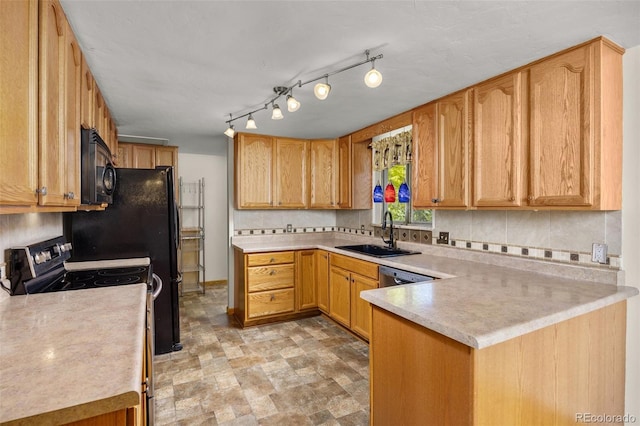 1026 Spencer St, Longmont, CO 80501 - kitchen featuring range, black microwave, a peninsula, light countertops, and tasteful backsplash
