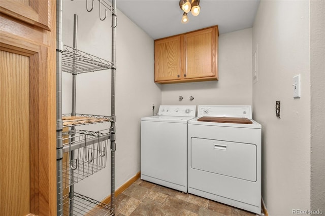1026 Spencer St, Longmont, CO 80501 - washroom with separate washer and dryer, cabinet space, and stone finish flooring