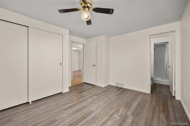 1026 Spencer St, Longmont, CO 80501 - unfurnished bedroom with wood finished floors, a closet, a ceiling fan, and ensuite bath