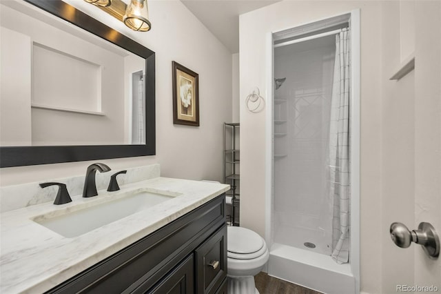 1026 Spencer St, Longmont, CO 80501 - bathroom featuring vanity, a stall shower, and wood finished floors