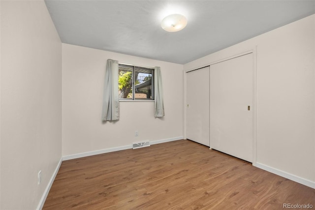 1026 Spencer St, Longmont, CO 80501 - unfurnished bedroom featuring wood finished floors and a closet