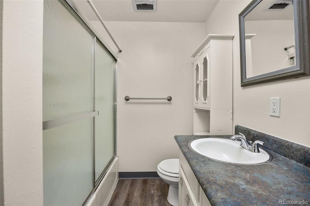 1026 Spencer St, Longmont, CO 80501 - full bathroom featuring wood finished floors, vanity, and combined bath / shower with glass door