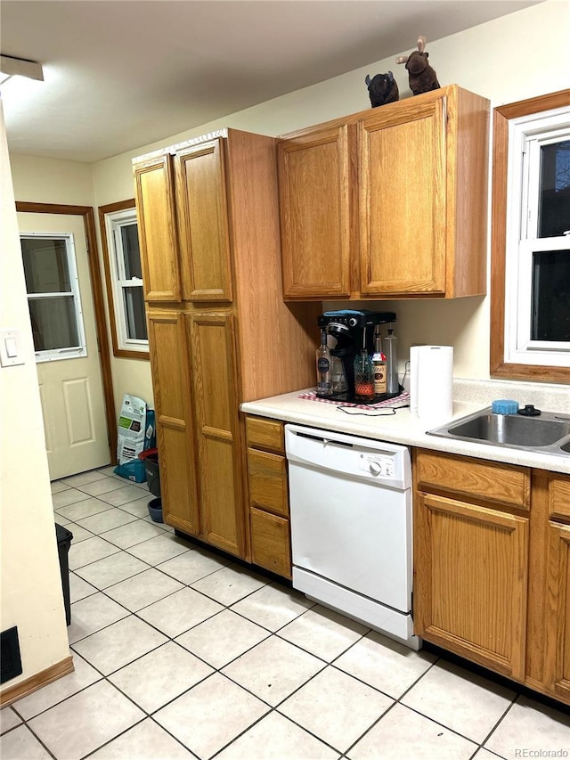 kitchen with sink, light tile patterned floors, and dishwasher