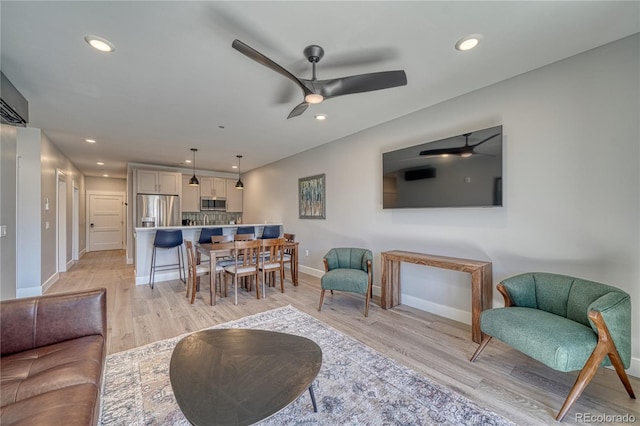 living room with recessed lighting and light wood-style floors